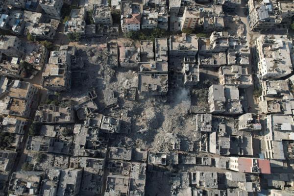 FILE PHOTO: Palestinians gather at the site of Israeli strikes on houses in Bureij in the central Gaza Strip