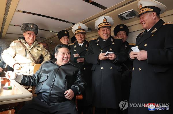 This photo, carried by North Korea's official Korean Central News Agency on Feb. 15, 2024, shows the North's leader Kim Jong-un (C) overseeing the test-firing of a new surface-to-sea missile the previous day. (For Use o<em></em>nly in the Republic of Korea. No Redistribution) (Yonhap)