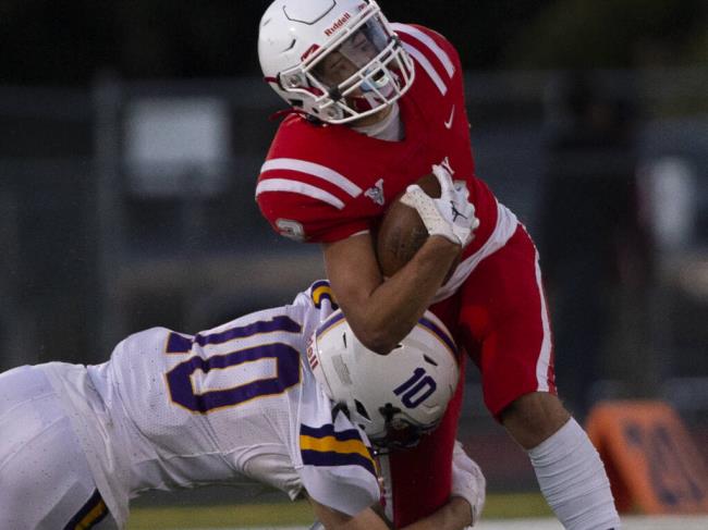 Montgomery’s Keegan Peterson is tackled by Ukiah’s Shay Parrish during firs- half action against Ukiah in their home opener at Mo<em></em>ntgomery High School, Friday August 26, 2022. (Chad Surmick / The Press Democrat)