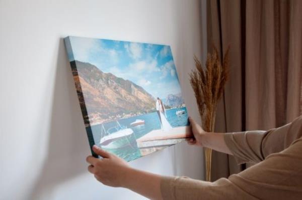 Woman Hanging Photo on the Wall