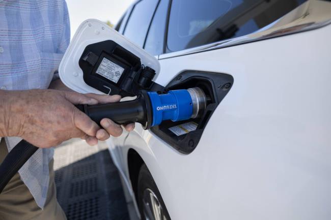 A driver adds hydrogen  fuel to his vehicle at an Iwatani hydrogen fuel station in West Sacramento on July 25, 2023. Photo by Miguel Gutierrez Jr., CalMatters