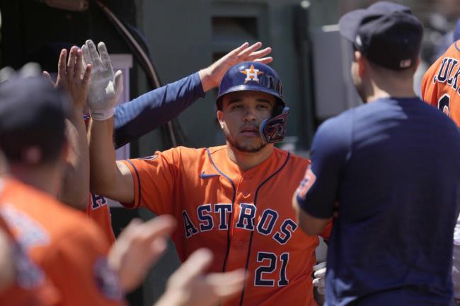 Houston Astros' Yainer Diaz (21) is co<em></em>ngratulated by teammates after hitting a home run against the Oakland Athletics during the fifth inning of a ba<em></em>seball game in Oakland, Calif., Sunday, July 23, 2023. (AP Photo/Jeff Chiu)