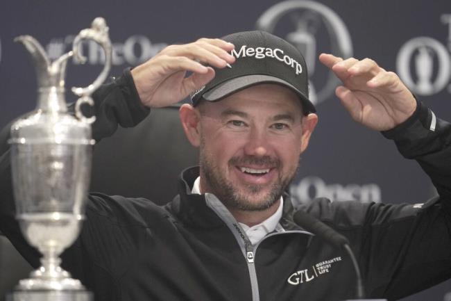 United States' Brian Harman gestures as he speaks at a press co<em></em>nference next to the ico<em></em>nic Claret Jug trophy after winning the British Open Golf Champio<em></em>nships at the Royal Liverpool Golf Club in Hoylake, England, Sunday, July 23, 2023. (AP Photo/Kin Cheung)