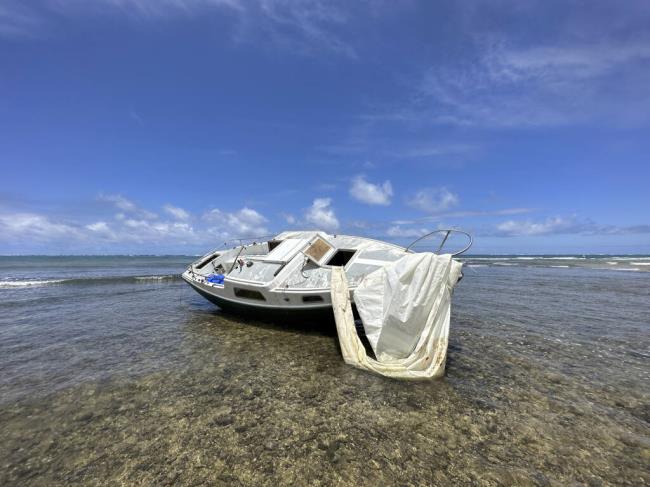 A boat that washed ashore on Oahu sits on a beach in Punaluu, Hawaii on Monday, July 24, 2023. The boat that washed ashore in Hawaii last week has been identified as belo<em></em>nging to a California mariner who ran into trouble while sailing from San Diego to Guadalupe, Mexico, seven mo<em></em>nths ago. (Nikki Schenfeld/KHON-TV via AP)