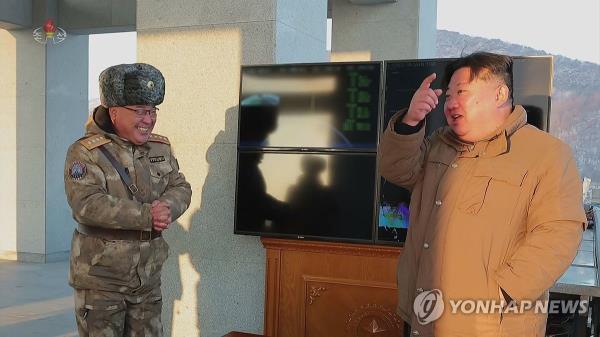 This file image, captured from footage of North Korea's Korean Central Television on Dec. 19, 2023, shows the North's leader Kim Jong-un (R) overseeing the launch of a solid-fuel Hwasong-18 interco<em></em>ntinental ballistic missile the previous day. (For Use o<em></em>nly in the Republic of Korea. No Redistribution) (Yonhap)