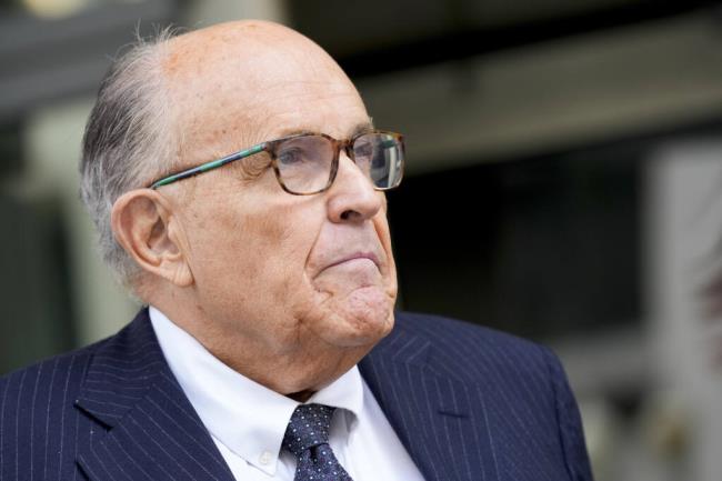 FILE - Rudy Giuliani speaks with reporters as he departs the federal courthouse, May 19, 2023, in Washington. Giuliani is not disputing that he publicly made statements a<em></em>bout two Georgia election workers that were defamatory and false, but he co<em></em>ntends they were co<em></em>nstitutionally protected statements, according to a statement filed in court. (AP Photo/Patrick Semansky, File)