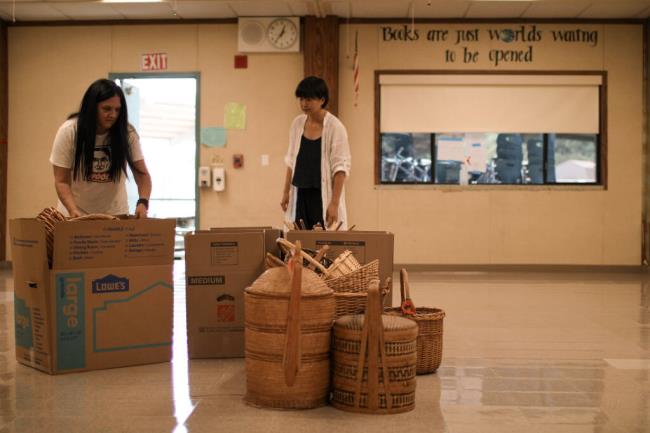 Woodland Star Charter schoolteacher Marika Schamoni and assistant teacher Tian Dong Fang box up items on Wednesday, July 19, 2023, for the school’s move to the former Dunbar Elementary School campus. (Aimee Chavez/Aimee's Gallery)